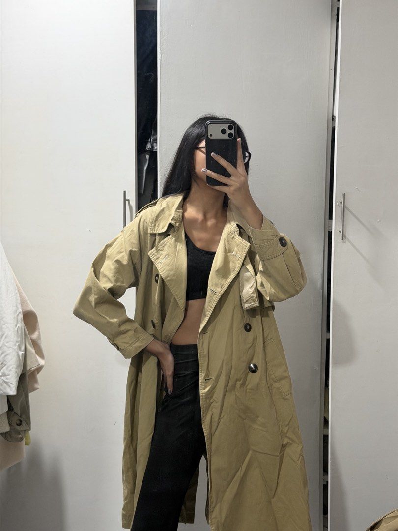 Classic beige double-breasted trench coat long outerwear (Category: Coats, Jackets and Outerwear) located in Pasig City. Submitted by miss_abuelita (Listing ID 1465115205, Image 2). Description: - Classic beige trench coat with a chic, oversized fit - Long length that falls below the knee - Stylish double-breasted tortoiseshell buttons - Detailed with shoulder epaulets and front storm flaps - Structured, premium material - Perfect layering piece 