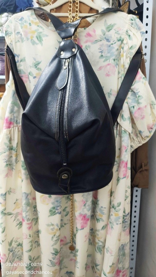 CLASSIC BLACK FAUX LEATHER CONVERTIBLE BACKPACK (Category: Backpacks) located in Kalibo. Submitted by secondchances.thriftsh8p (Listing ID 1465134846, Image 2). Description: - Style: Black faux leather backpack - Condition: Minimal wear on hardware, clean structure and durable stitching - Features: Adjustable shoulder straps, secure zip-around front closure, and snap button flap detail - Versatility: Great everyday size for campus, work, or casua