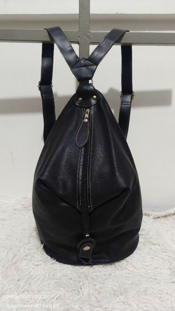 CLASSIC BLACK FAUX LEATHER CONVERTIBLE BACKPACK (Category: Backpacks) located in Kalibo. Submitted by secondchances.thriftsh8p (Listing ID 1465134846, Image 1). Description: - Style: Black faux leather backpack - Condition: Minimal wear on hardware, clean structure and durable stitching - Features: Adjustable shoulder straps, secure zip-around front closure, and snap button flap detail - Versatility: Great everyday size for campus, work, or casua