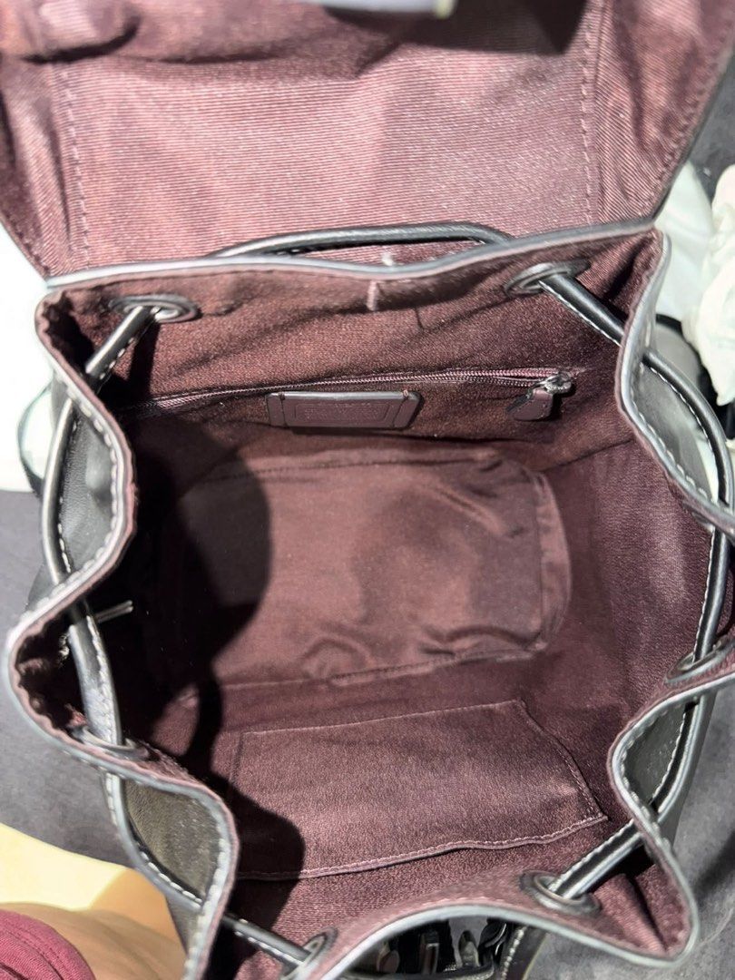 Coach Black Leather Backpack with Dust Bag (Category: Luxury Bags & Wallets) located in Makati City. Submitted by konomi.phh (Listing ID 1465080234, Image 3). Description: - Brand: Coach - Color: Classic Black - Material: Premium Leather with Silver Hardware - Closure: Drawstring under a flap with snap buckle - Pockets: Front zip pocket, plus interior zipper and slip pockets - Comfort: Adjustable shoulder straps - Inclusion: Original Coach dust b