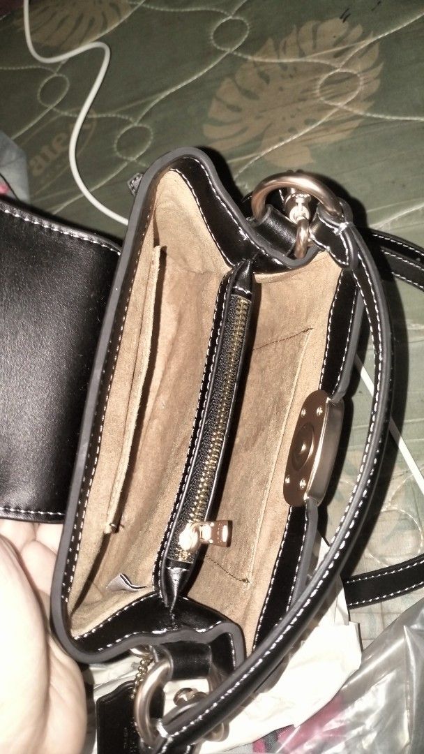 Coach Black Leather Crossbody Bag (Category: Cross-body Bags) located in Quezon City. Submitted by borresashl49573 (Listing ID 1465136145, Image 3). Description: - Brand: Coach - Material: Premium black leather with gold-tone hardware 😍 - Closure: Prominent logo plate closure. Super duper classy in person! ♥️🫣 - Straps: Includes a top handle and an adjustable, detachable shoulder strap - Base: Four protective metal feet stamped with the brand n