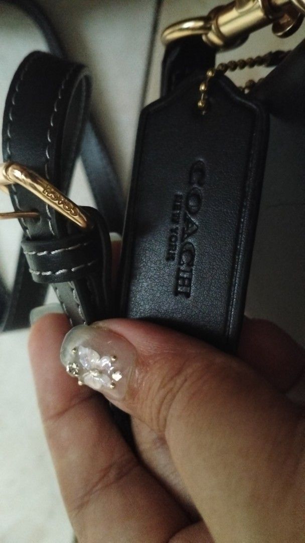 Coach Black Leather Crossbody Bag (Category: Cross-body Bags) located in Quezon City. Submitted by borresashl49573 (Listing ID 1465136145, Image 2). Description: - Brand: Coach - Material: Premium black leather with gold-tone hardware 😍 - Closure: Prominent logo plate closure. Super duper classy in person! ♥️🫣 - Straps: Includes a top handle and an adjustable, detachable shoulder strap - Base: Four protective metal feet stamped with the brand n