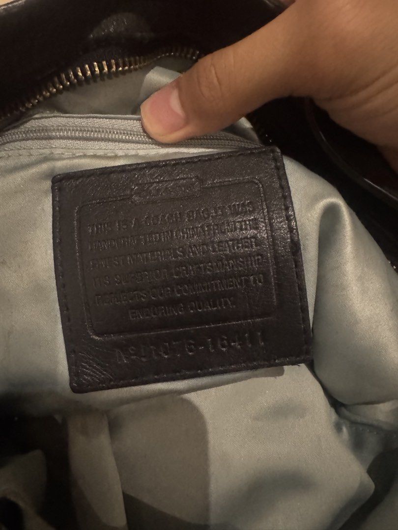 Coach Black Leather Hobo Shoulder Bag (Category: Luxury Bags & Wallets) located in Makati City. Submitted by lumpiawrapper (Listing ID 1465108799, Image 3). Description: - Brand: Coach - Style: Black leather hobo bag with silver hardware - Design: Adjustable strap, buckle details on the sides, and a center vertical leather stripe on the front - Interior: Beautiful light blue satin lining with a zip pocket and slip compartments - Authenticity: Inc