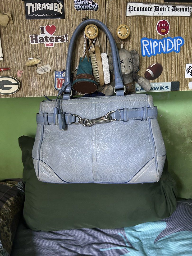 Coach Leather Handbag Light Blue (Category: Luxury Bags & Wallets) located in Quezon City. Submitted by thriftxgoods (Listing ID 1465000137, Image 1). Description: - Authentic Coach Pebble Leather Handbag in Light Blue - Silver-tone hardware with secure front clasp closure - Double top handles for comfortable carrying - Includes signature Coach leather tag and tassel charm - Metal protective feet on the bottom base - Interior compartments with zi