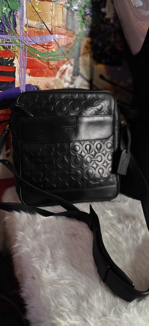 Coach Leather Monogram Messenger Crossbody Bag Black (Category: Luxury Bags & Wallets) located in Las Pinas. Submitted by liezel49 (Listing ID 1465015085, Image 1). Description: - Brand: Coach messenger bag - Color: Classic black - Material: Premium leather with all-over debossed monogram pattern - Hardware: Stylish brass accents on the sides - Storage: Front slip pocket and clean structured main compartment - Includes: Adjustable shoulder strap 