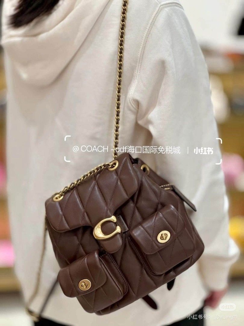 Coach Quilted Leather Backpack (Category: Backpacks) located in Manila. Submitted by onlineshopmate (Listing ID 1465136443, Image 2). Description: - Brand: Coach - Material: Quilted leather in a rich brown shade - Hardware: Antique brass tone - Closure: Signature C turnlock on main flap with drawstring underneath - Pockets: Twin front utility pockets - Straps: Chain top handle and adjustable leather shoulder straps - Condition: Brand new (protect