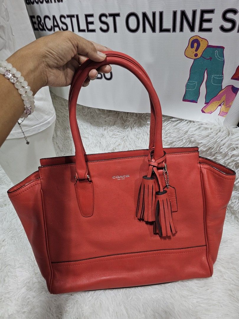 Coach Red Leather Tote Bag with Tassel (Category: Luxury Bags & Wallets) located in Cavite. Submitted by liveriver_514fd1 (Listing ID 1464986892, Image 3). Description: - Brand: Coach - Color: Bright Red - Material: Genuine Leather - Hardware: Silver - Features: Dual shoulder handles, matching tassel charm, exterior vertical zip pocket - Interior: Roomy and structured for daily essentials - Condition: Excellent / Well-maintained .