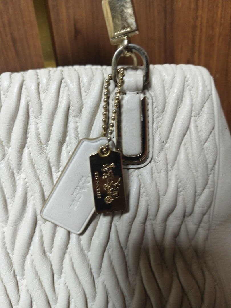 Coach Ruched Leather Satchel Bag (Category: Clutches) located in Baguio. Submitted by PreiLoveMaria (Listing ID 1465108505, Image 3). Description: Coach Ruched Leather Satchel Bag 🤍 Classic, chic, and sophisticated! This gorgeous Coach satchel features a stylish chevron-quilted/ruched leather design with gold-tone hardware and signature charms. A timeless piece that elevates any outfit. Good used condition with normal signs of wear. Please check