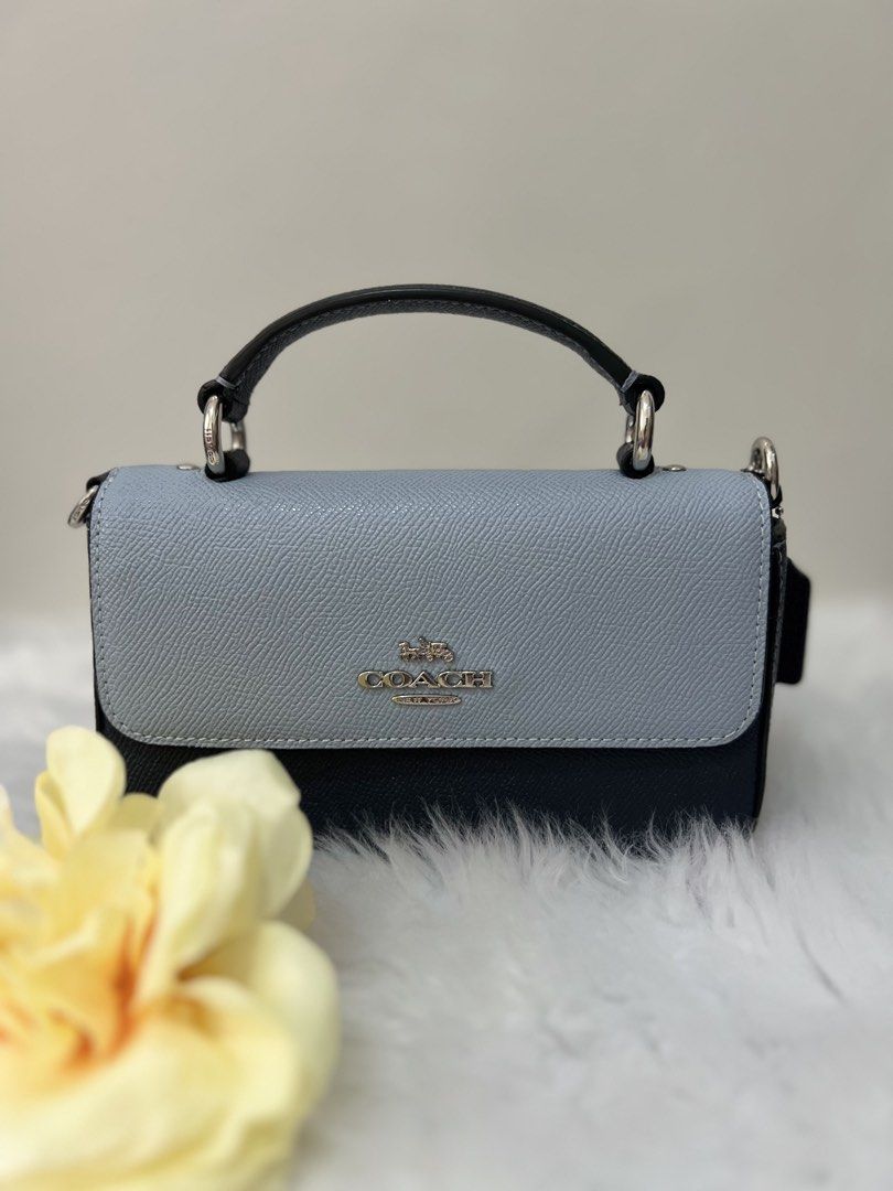 Coach Two-Tone Leather Crossbody Bag (Category: Luxury Bags & Wallets) located in Imus. Submitted by _reignlao (Listing ID 1465009493, Image 3). Description: - Authentic Coach crossbody bag - Chic two-tone design: light blue flap top with dark navy body - Premium structured leather build with silver-tone hardware - Front Coach logo branding - Versatile with a matching adjustable leather strap and top handle - Clean interior and exterior, ready fo