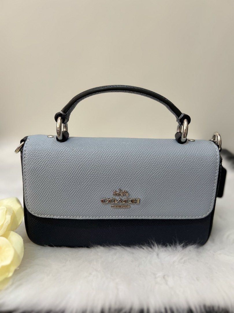 Coach Two-Tone Leather Crossbody Bag (Category: Luxury Bags & Wallets) located in Imus. Submitted by _reignlao (Listing ID 1465009493, Image 2). Description: - Authentic Coach crossbody bag - Chic two-tone design: light blue flap top with dark navy body - Premium structured leather build with silver-tone hardware - Front Coach logo branding - Versatile with a matching adjustable leather strap and top handle - Clean interior and exterior, ready fo