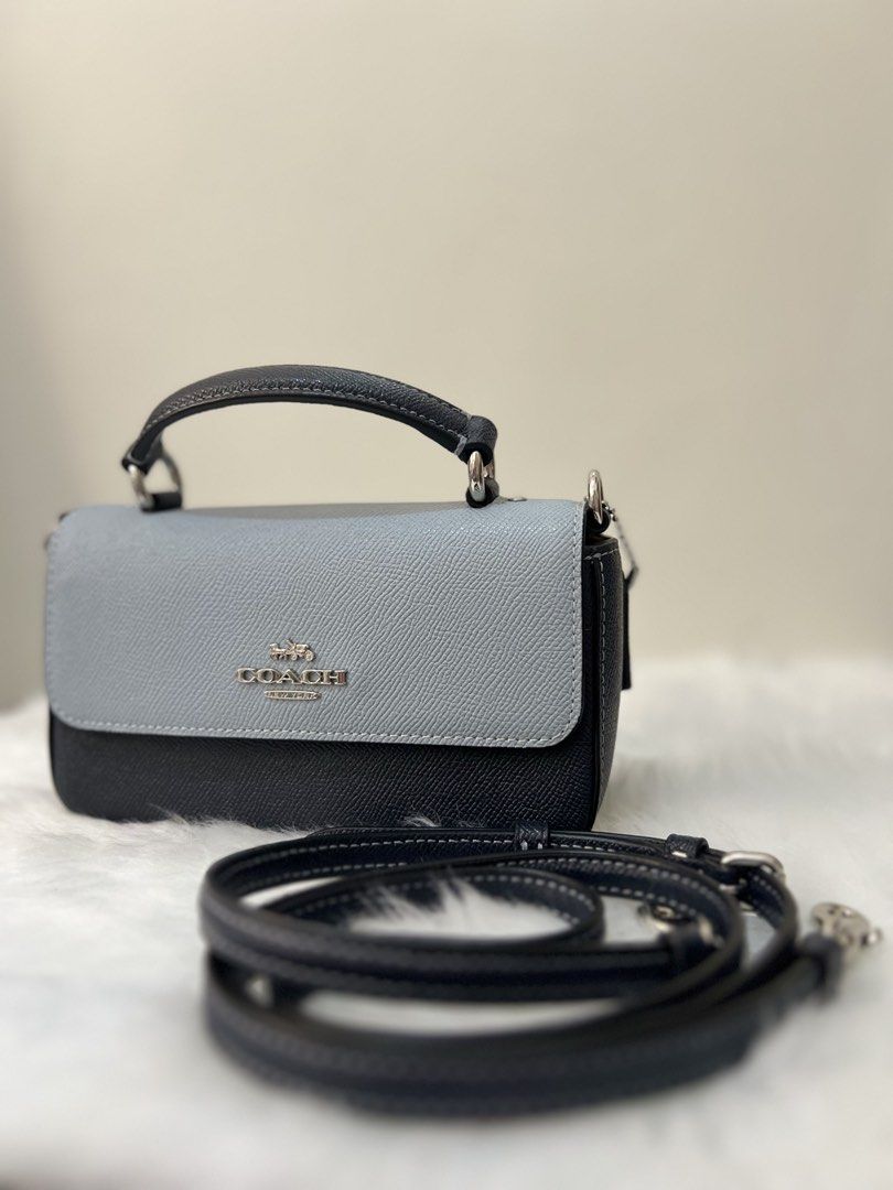 Coach Two-Tone Leather Crossbody Bag (Category: Luxury Bags & Wallets) located in Imus. Submitted by _reignlao (Listing ID 1465009493, Image 1). Description: - Authentic Coach crossbody bag - Chic two-tone design: light blue flap top with dark navy body - Premium structured leather build with silver-tone hardware - Front Coach logo branding - Versatile with a matching adjustable leather strap and top handle - Clean interior and exterior, ready fo