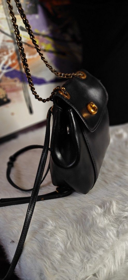 Coach vintage Black Leather Mini Backpack with Gold Chain Straps (Category: Luxury Bags & Wallets) located in Las Pinas. Submitted by liezel49 (Listing ID 1465016162, Image 3). Description: Chic black leather mini backpack with antique gold hardware and a classic turn-lock closure. Features versatile convertible straps, a secure back zipper pocket, and a clean structure. Perfect stylish everyday bag for your daily essentials..