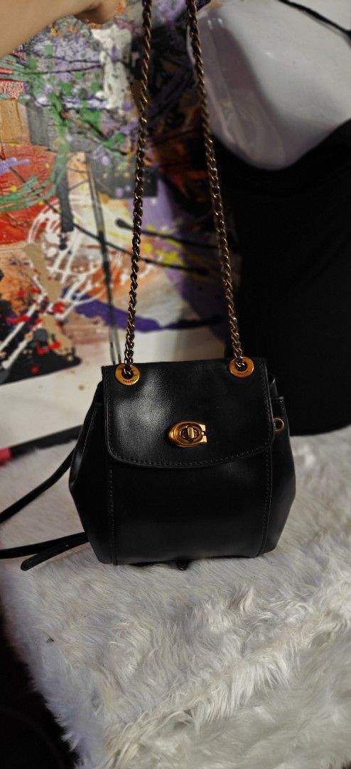 Coach vintage Black Leather Mini Backpack with Gold Chain Straps (Category: Luxury Bags & Wallets) located in Las Pinas. Submitted by liezel49 (Listing ID 1465016162, Image 1). Description: Chic black leather mini backpack with antique gold hardware and a classic turn-lock closure. Features versatile convertible straps, a secure back zipper pocket, and a clean structure. Perfect stylish everyday bag for your daily essentials..