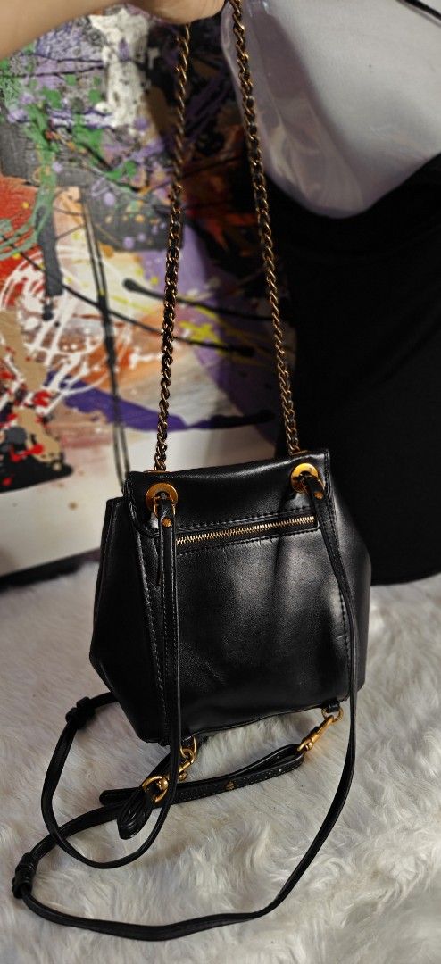 Coach vintage Black Leather Mini Backpack with Gold Chain Straps (Category: Luxury Bags & Wallets) located in Las Pinas. Submitted by liezel49 (Listing ID 1465016162, Image 2). Description: Chic black leather mini backpack with antique gold hardware and a classic turn-lock closure. Features versatile convertible straps, a secure back zipper pocket, and a clean structure. Perfect stylish everyday bag for your daily essentials..