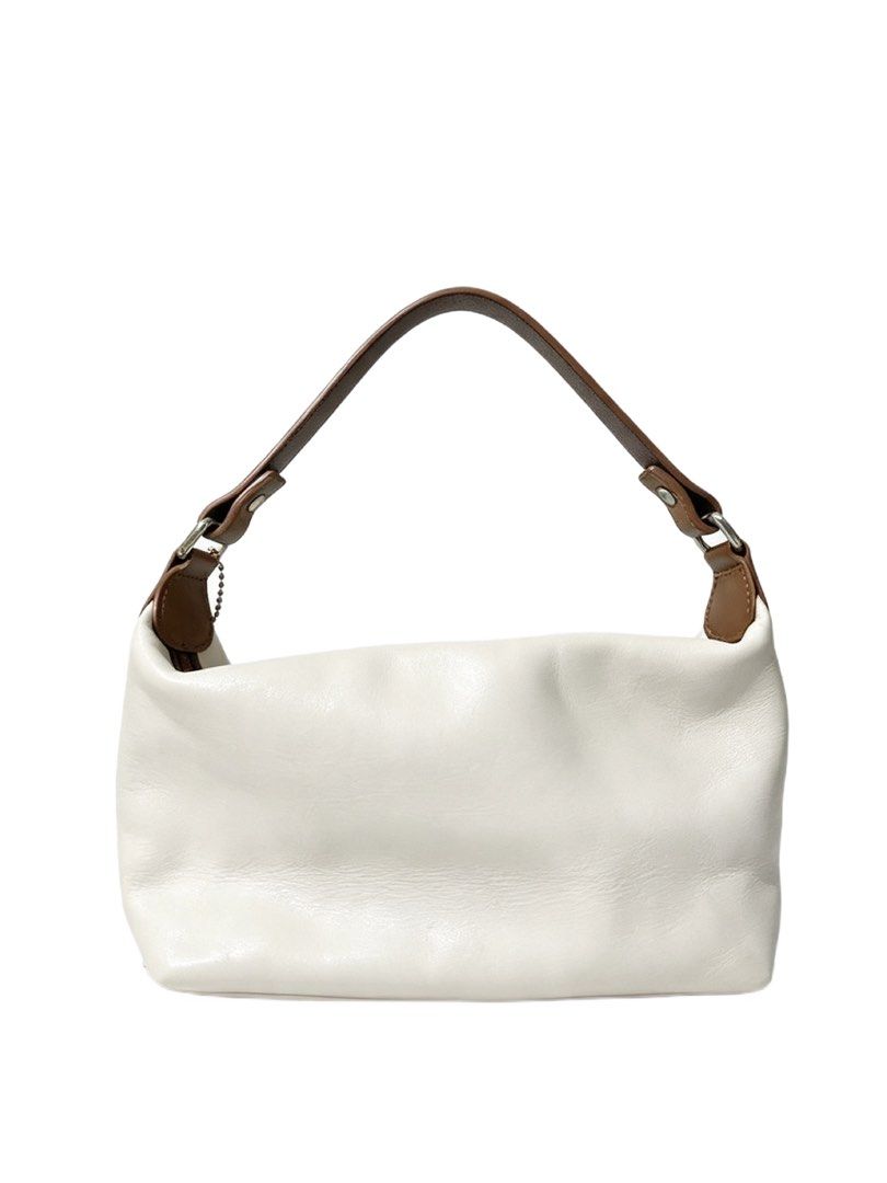 Coach White Leatherware Est 1941 Shoulder Bag (Category: Luxury Bags & Wallets) located in Quezon City. Submitted by un0oo (Listing ID 1465013189, Image 2). Description: - Authentic Coach shoulder bag - Color: White leather with brown contrast strap and trim - Front embossed Coach Leatherware Est 1941 logo - Includes matching brown leather hangtag on a beaded chain - Secure top zipper closure - Compact size, ideal for daily essentials.