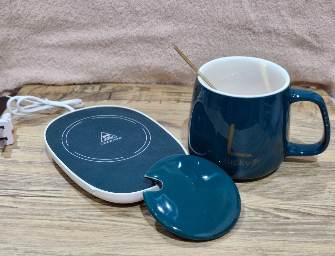 Coffee Mug With Electric Warmer Coaster And Spoon (Category: Coffee & Tea Tableware) located in Davao. Submitted by j_guitarist (Listing ID 1465072418, Image 3). Description: - Color: Dark green ceramic mug with elegant gold spoon - Size: 400ml - Power: 16 watts - Features built-in electric heating coaster to keep drinks warm at your desk - Includes a matching lid to trap heat and dust - Beautifully packaged in an original dark green presentation