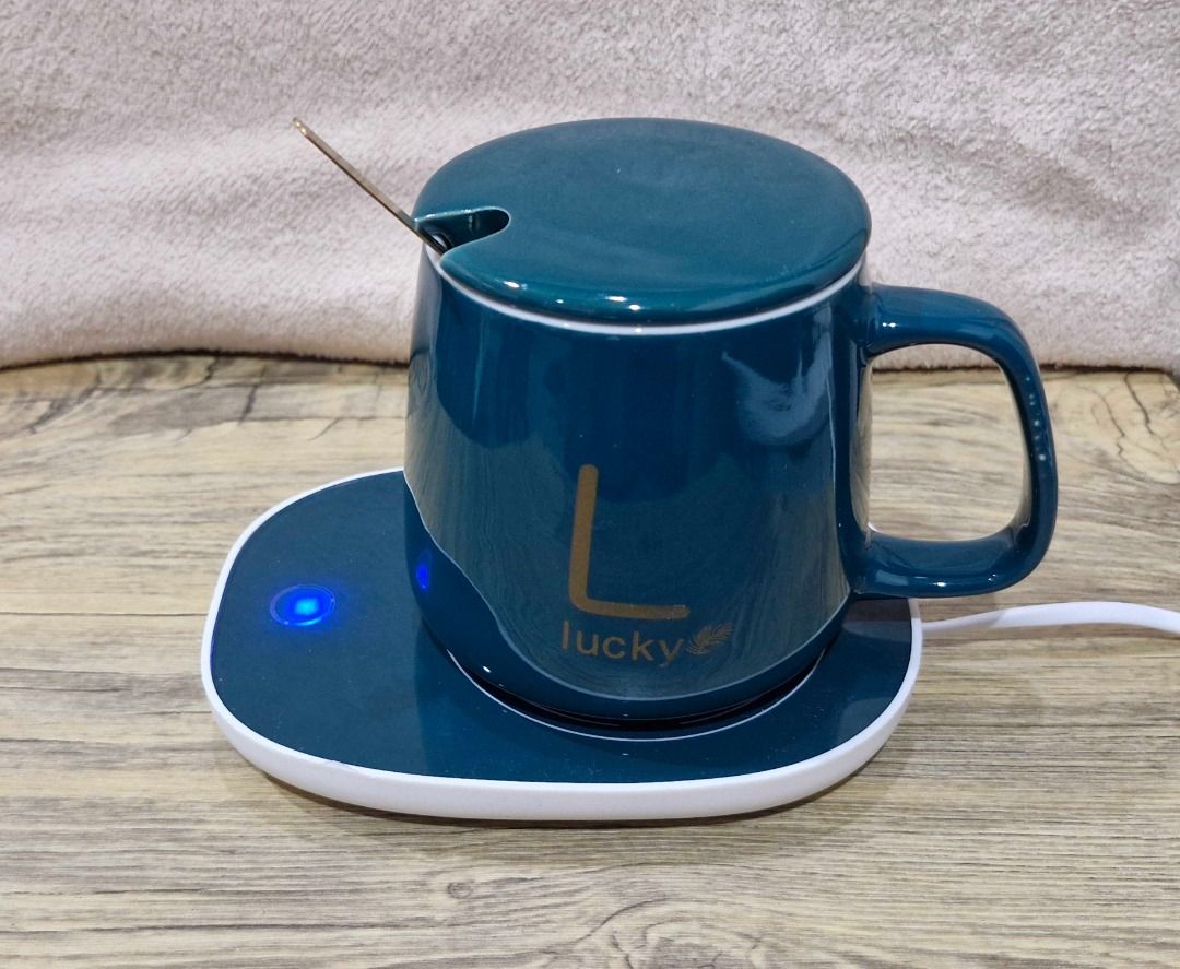 Coffee Mug With Electric Warmer Coaster And Spoon (Category: Coffee & Tea Tableware) located in Davao. Submitted by j_guitarist (Listing ID 1465072418, Image 2). Description: - Color: Dark green ceramic mug with elegant gold spoon - Size: 400ml - Power: 16 watts - Features built-in electric heating coaster to keep drinks warm at your desk - Includes a matching lid to trap heat and dust - Beautifully packaged in an original dark green presentation