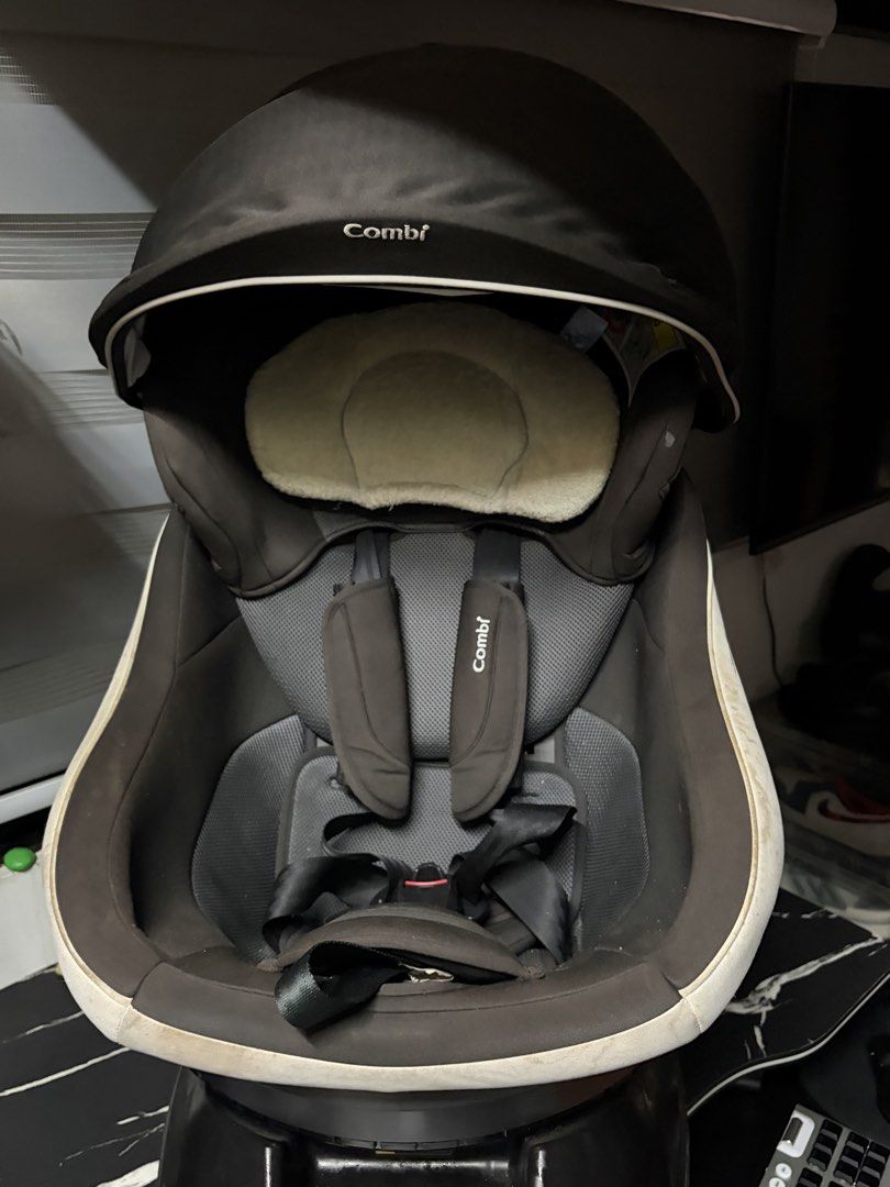 Combi ISOFIX Rotating Car Seat (Category: Car Seats) located in Manila. Submitted by arelsnts (Listing ID 1465036384, Image 1). Description: - Authentic Combi child car seat with ISOFIX base - Stylish black and dark grey mesh fabric with a comfy cream headrest insert - Convenient 360-degree rotation mechanism for easy loading - Built-in canopy hood to protect your little one from the sun - Adjustable recline with side knob and secure harness stra