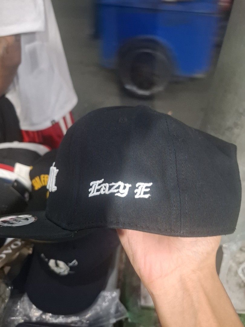 Compton Snapback Cap Black Eazy E (Category: Caps & Hats) located in Manila. Submitted by young_thrift001 (Listing ID 1465058219, Image 2). Description: - Color: Classic black with white embroidery - Front Design: Bold Compton embroidered text - Side Detail: Iconic Eazy-E embroidery - Fit: Adjustable snap closure at the back - Structure: Structured crown and flat brim - Interior: Authentic Major League Baseball branded taping.