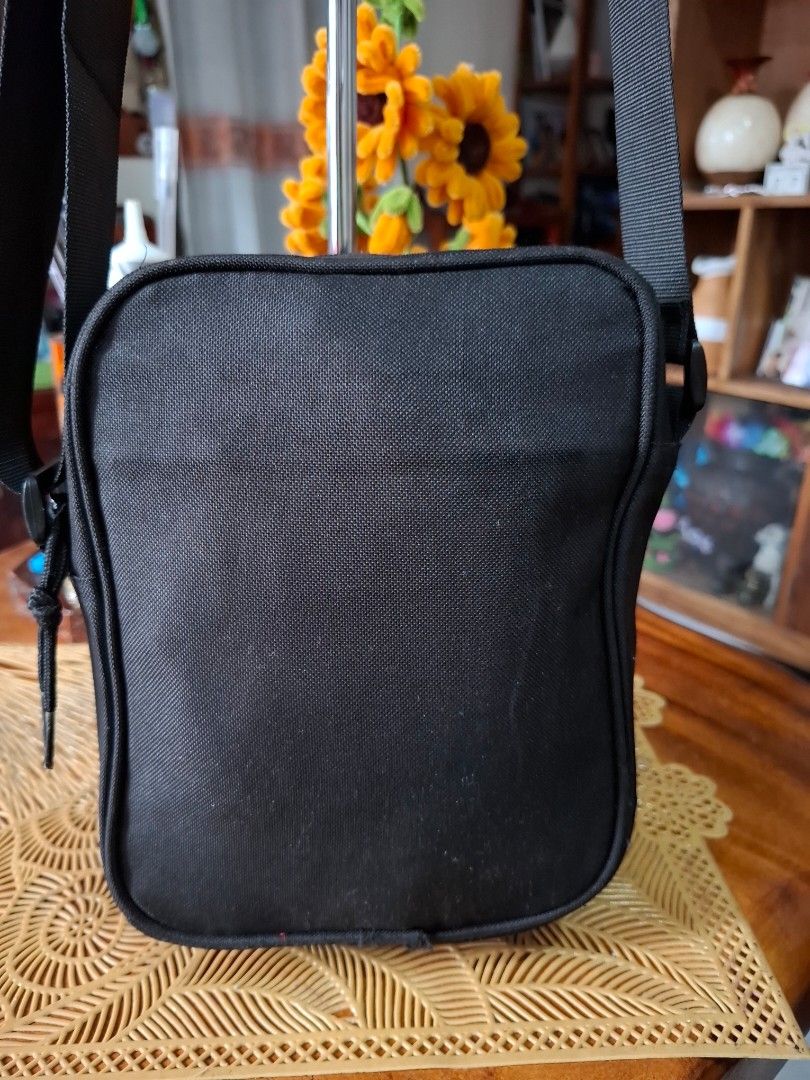 Converse Black Crossbody Sling Bag (Category: Sling Bags) located in Libon. Submitted by jaladzarmi80045 (Listing ID 1465033740, Image 3). Description: - Brand: Converse - Color: Classic Black - Material: Durable canvas construction - Design: Iconic Chuck Taylor All Star round patch on front - Compartments: Secure main zip compartment - Strap: Adjustable black shoulder strap - Condition: Clean overall, great for daily use - Capacity: Fits essenti