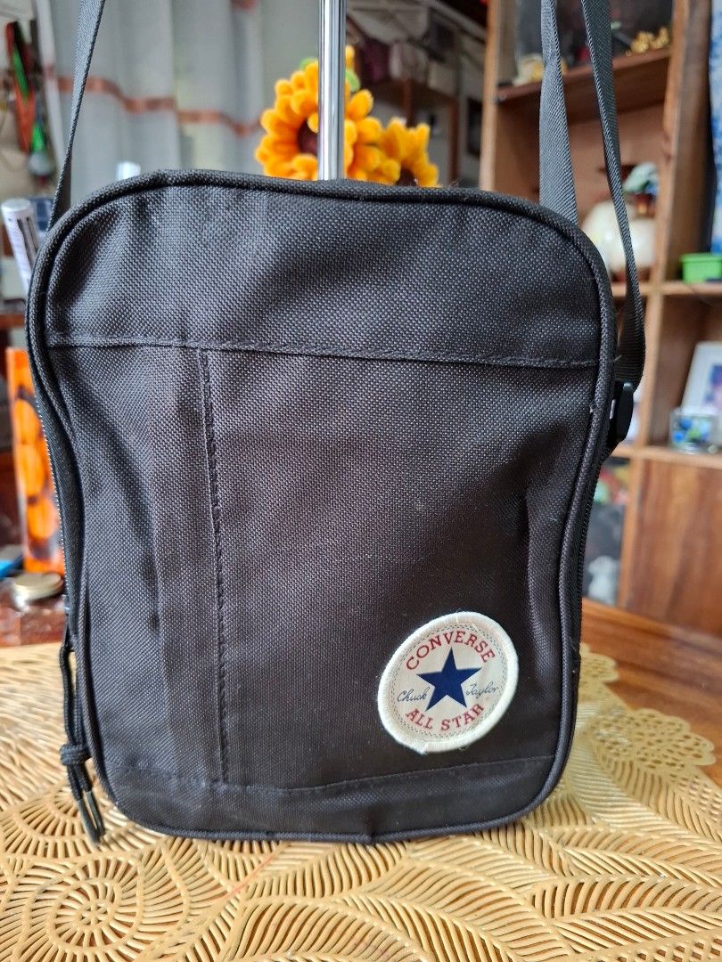 Converse Black Crossbody Sling Bag (Category: Sling Bags) located in Libon. Submitted by jaladzarmi80045 (Listing ID 1465033740, Image 2). Description: - Brand: Converse - Color: Classic Black - Material: Durable canvas construction - Design: Iconic Chuck Taylor All Star round patch on front - Compartments: Secure main zip compartment - Strap: Adjustable black shoulder strap - Condition: Clean overall, great for daily use - Capacity: Fits essenti