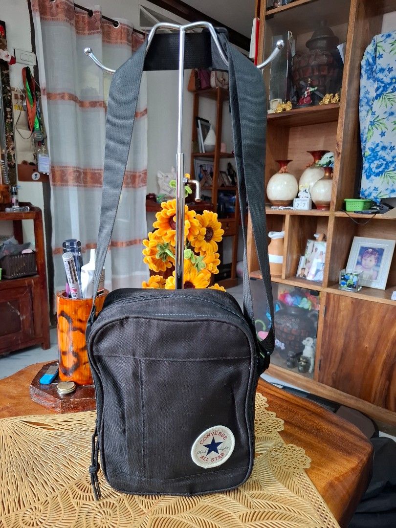 Converse Black Crossbody Sling Bag (Category: Sling Bags) located in Libon. Submitted by jaladzarmi80045 (Listing ID 1465033740, Image 1). Description: - Brand: Converse - Color: Classic Black - Material: Durable canvas construction - Design: Iconic Chuck Taylor All Star round patch on front - Compartments: Secure main zip compartment - Strap: Adjustable black shoulder strap - Condition: Clean overall, great for daily use - Capacity: Fits essenti