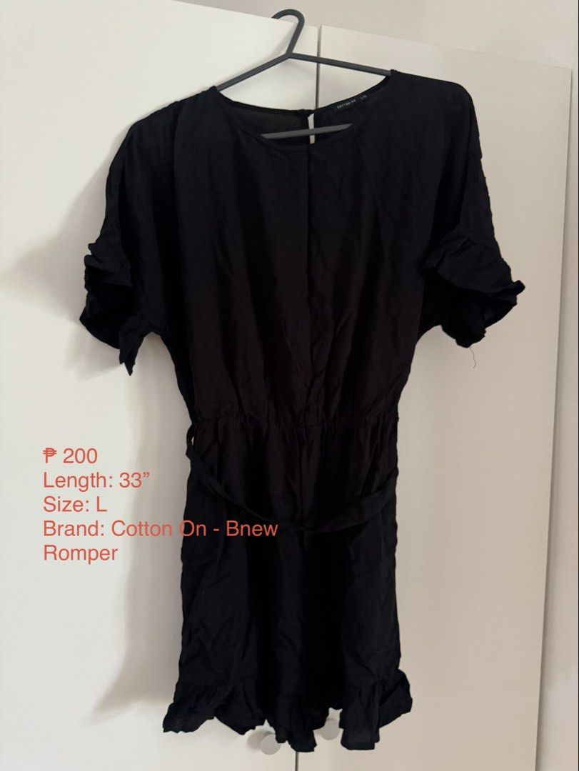 Cotton On Black Romper Size L (Category: Rompers) located in Binan City. Submitted by izza1311 (Listing ID 1464997607, Image 1). Description: - Brand: Cotton On - Size: L - Color: Plain Black - Length: 33 inches - Details: Short sleeves with ruffled cuffs, matching hem, and built-in tie belt at the waist .
