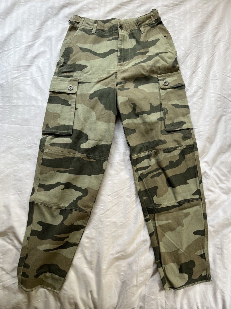 Cotton On Camo Cargo Pants Size 2 / AUS 6 (Category: Jeans) located in Manila. Submitted by tidymarket (Listing ID 1464996887, Image 1). Description: - Brand: Cotton On - Design: Green and beige camo print with raw hems - Fit: Women's AUS size 6 / US size 2, mid-rise waist, straight-leg cut - Details: Button fly and multiple functional thigh utility pockets - Material: 100% cotton fabric.