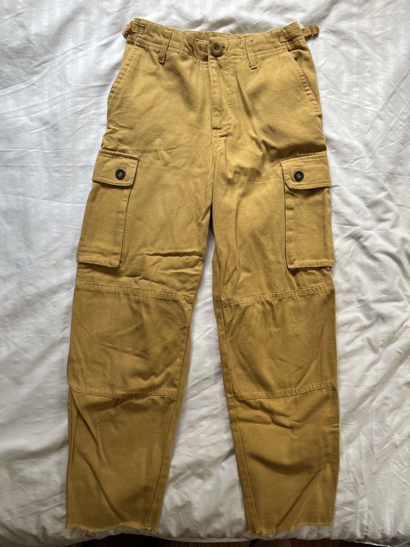 Cotton On Cargo Pants Size 6 (Category: Jeans) located in Manila. Submitted by tidymarket (Listing ID 1464996555, Image 1). Description: - Brand: Cotton On - Color: In between orange and brown - Size: AUS 6 / US 2 / EUR 34 - Material: 100% cotton - Features: Utility side pockets, belt loops, button fly - Fit: Straight leg with raw frayed ankle hems.