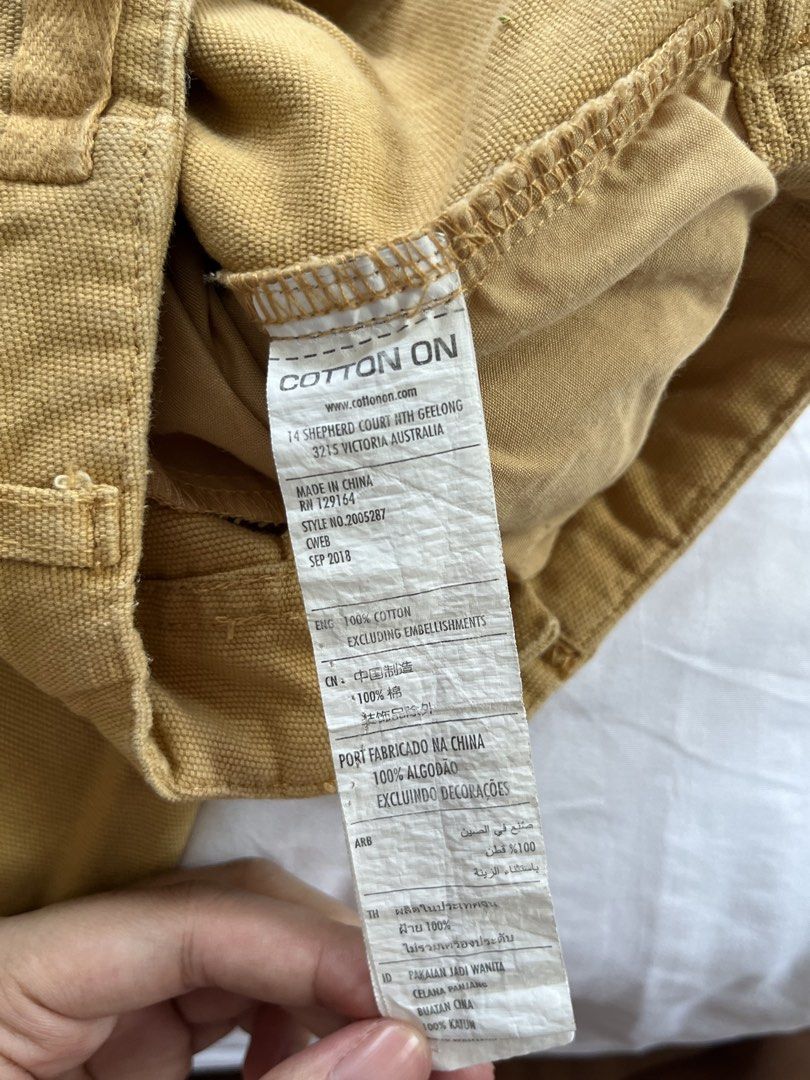 Cotton On Cargo Pants Size 6 (Category: Jeans) located in Manila. Submitted by tidymarket (Listing ID 1464996555, Image 3). Description: - Brand: Cotton On - Color: In between orange and brown - Size: AUS 6 / US 2 / EUR 34 - Material: 100% cotton - Features: Utility side pockets, belt loops, button fly - Fit: Straight leg with raw frayed ankle hems.