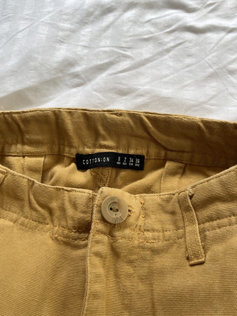 Cotton On Cargo Pants Size 6 (Category: Jeans) located in Manila. Submitted by tidymarket (Listing ID 1464996555, Image 2). Description: - Brand: Cotton On - Color: In between orange and brown - Size: AUS 6 / US 2 / EUR 34 - Material: 100% cotton - Features: Utility side pockets, belt loops, button fly - Fit: Straight leg with raw frayed ankle hems.