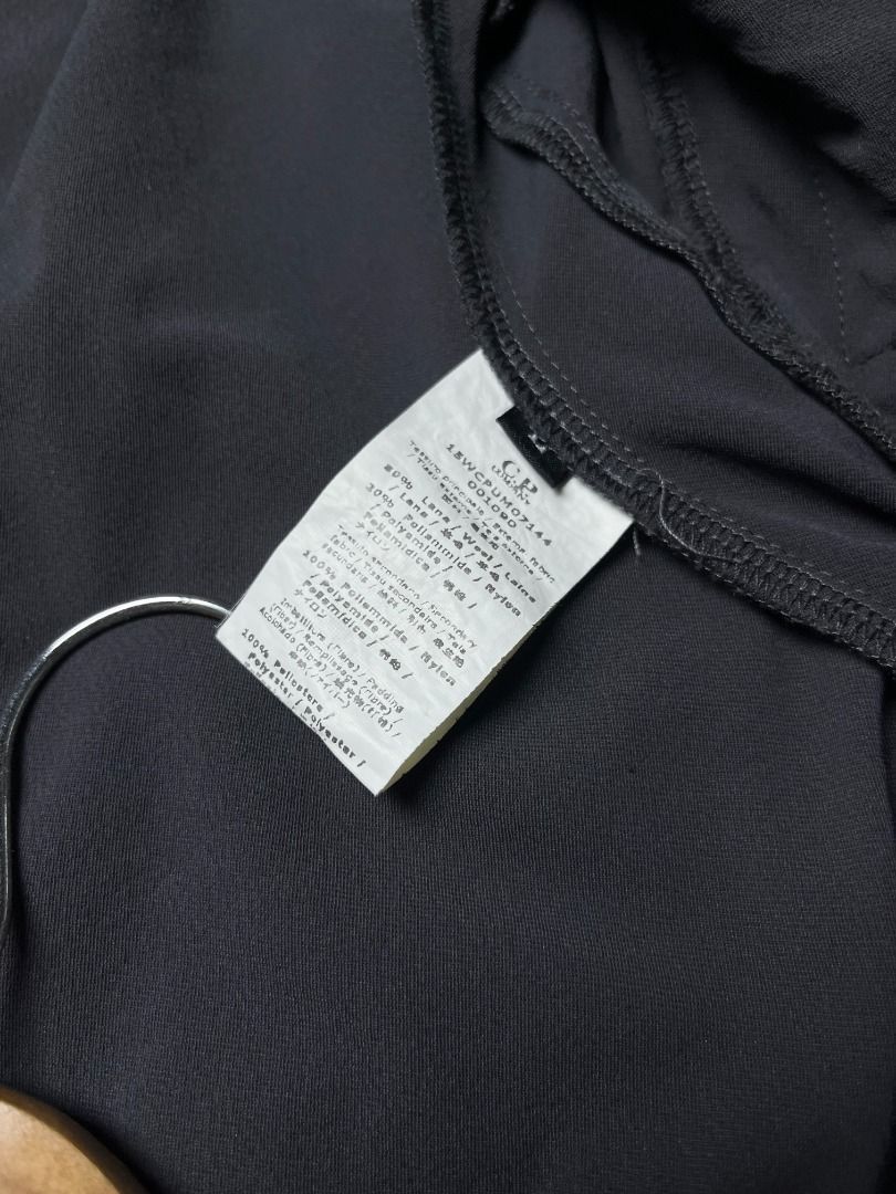 C.P. Company Goggle Hooded Soft Shell Jacket Dark Grey (Category: Coats, Jackets and Outerwear) located in Leyte. Submitted by carlthriftwearapparel (Listing ID 1465008662, Image 3). Description: - Brand: C.P. Company - Color: Dark grey with contrasting black hood - Iconic Details: Built-in goggle lenses on hood and sleeve pocket - Pockets: Multiple zippered pockets on the front - Material: Warm down and white duck feather filling - Features: Rib