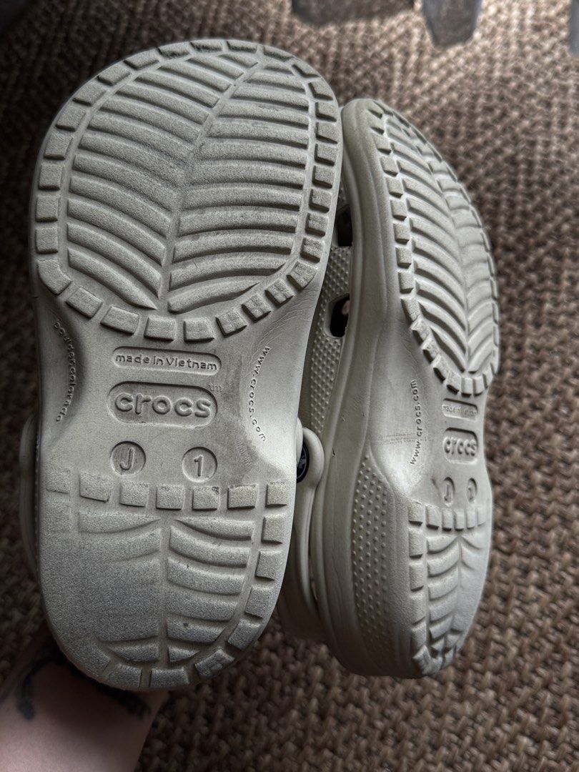 Crocs Classic Clogs Off White Cream with Jibbitz (Category: Babies & Kids Fashion) located in Manila. Submitted by veeroonniiccaa (Listing ID 1465057315, Image 1). Description: - Size: Kids J1 - Color: Off-white - Origin: Made in Vietnam - Extras: Includes 2 Among Us Jibbitz charms (Red & Black) - Features: Slip-on style with pivoting heel straps - Condition: Clean overall, ready to wear with light wear on bottom tread.