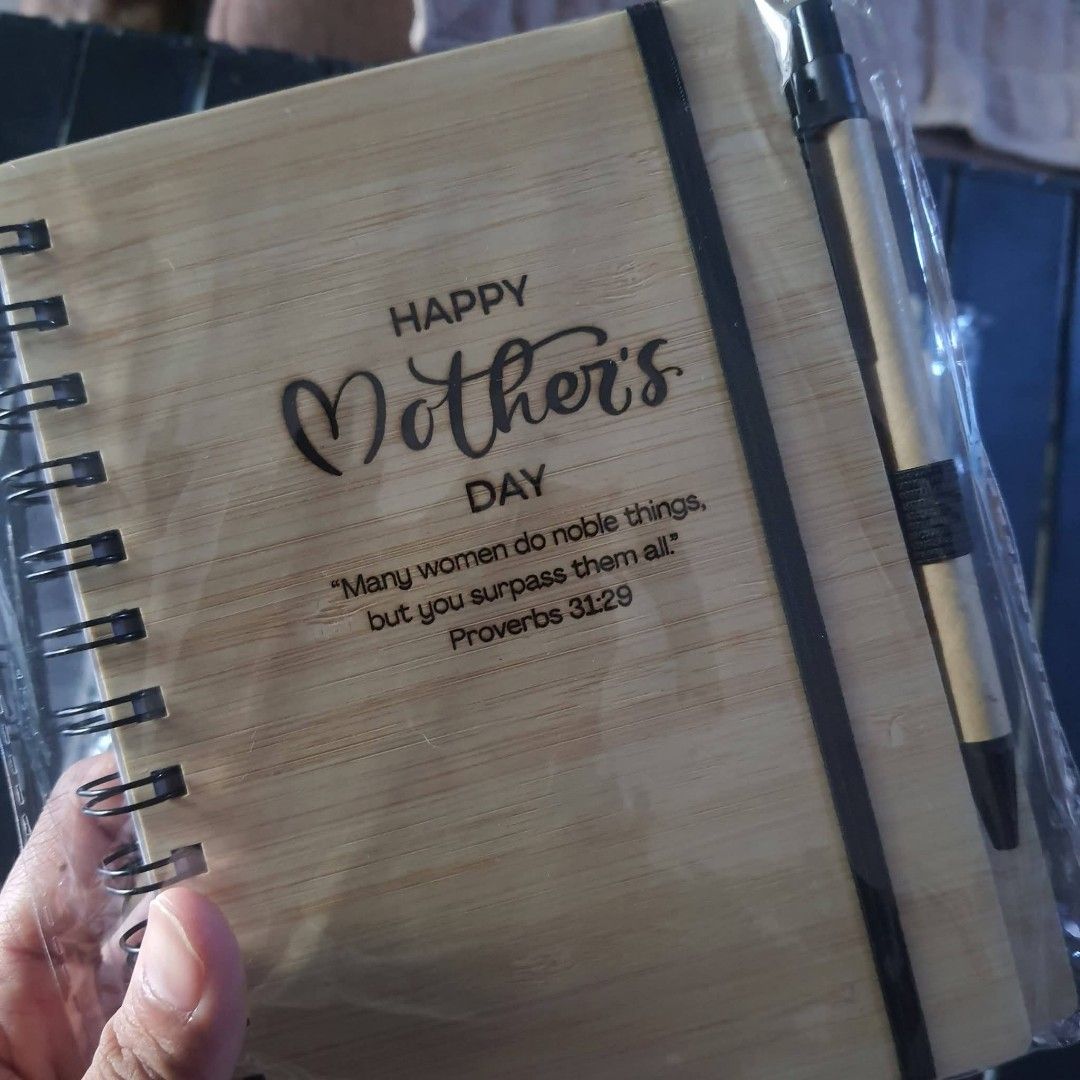Custom Engraved Bamboo Notebook with Pen (Category: Stationery & School Supplies) located in Tarlac. Submitted by jajubells (Listing ID 1465057041, Image 2). Description: - Material: Eco-friendly bamboo wood cover with spiral binding - Includes: Matching pen secured with an elastic band - Personalization: Free laser-engraved names or custom designs on the cover - Ideal for: Personalized gifts, teachers' day, souvenirs, and corporate giveaways - P