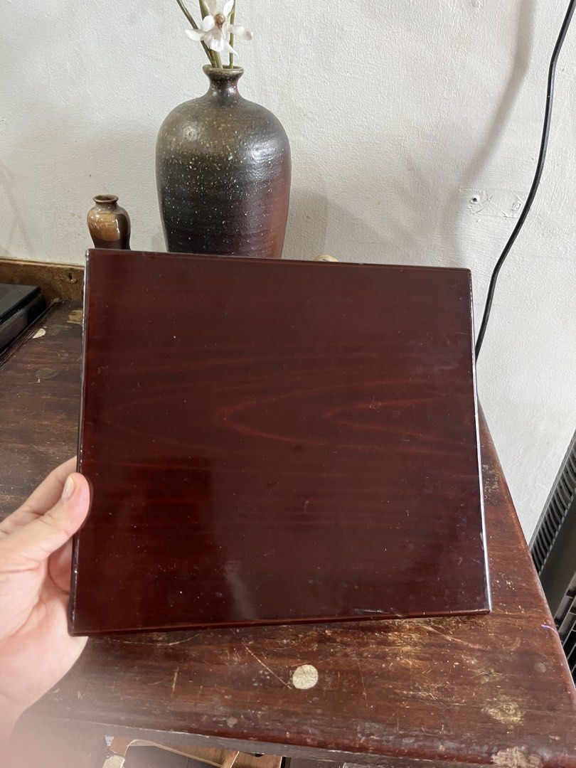 Dark Brown Glossy Wooden Lacquer Serving Tray (Category: Shelves, Cabinets & Racks) located in Taguig. Submitted by minmin_parker (Listing ID 1465020782, Image 3). Description: - Type: Square wooden tray - Finish: Dark brown lacquer with a high-gloss, light-reflecting surface and visible wood grain - Design: Flat base with raised edges to keep items secure - Uses: Ideal for serving tea and coffee, or organizing tabletop essentials - Condition: Cl