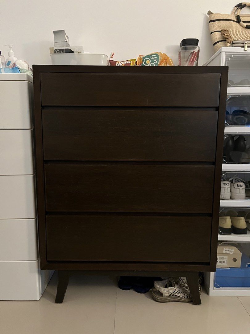 Dark Brown Wooden 4-Drawer Chest (Category: Shelves, Cabinets & Racks) located in Cavite. Submitted by bihnibini (Listing ID 1465049362, Image 2). Description: -location: Indang, Cavite - Dark brown wooden chest with 4 spacious drawers - Mid-century modern design with slender angled legs - Solid and sturdy build, perfect for clothes or bedroom accessories - Fits easily in small to medium-sized bedrooms - Note: Shows minor surface scratches on the
