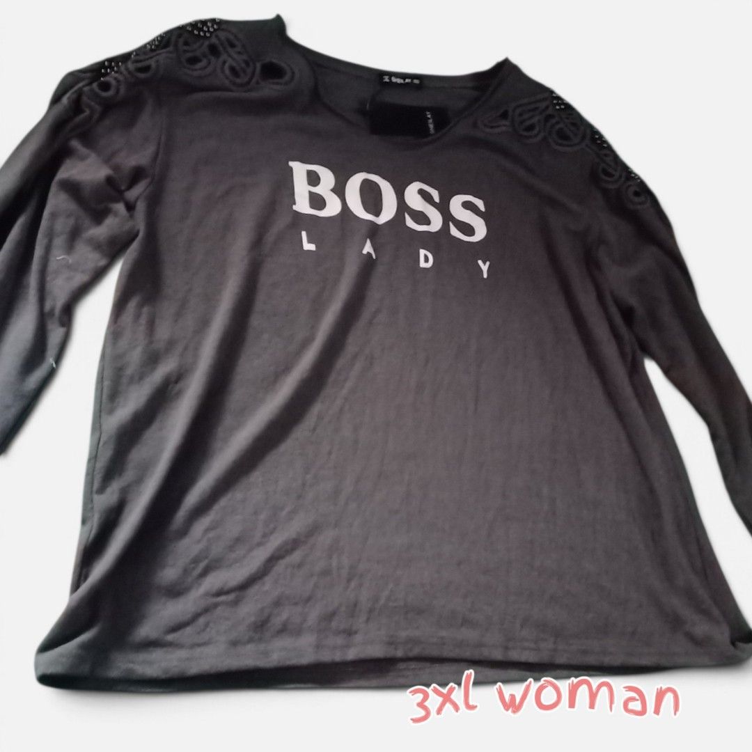 Dark Grey Long Sleeve Top 3XL (Category: Longsleeves) located in Manila. Submitted by crustynico23 (Listing ID 1464974113, Image 1). Description: - Dark grey long sleeve top with brand tag attached - Features a bold white 'Boss Lady' graphic on the front - Trendy cutout shoulders with stitched patterns and bead embellishments - Classic crew neckline with a relaxed, comfortable fit - Size: 3XL.