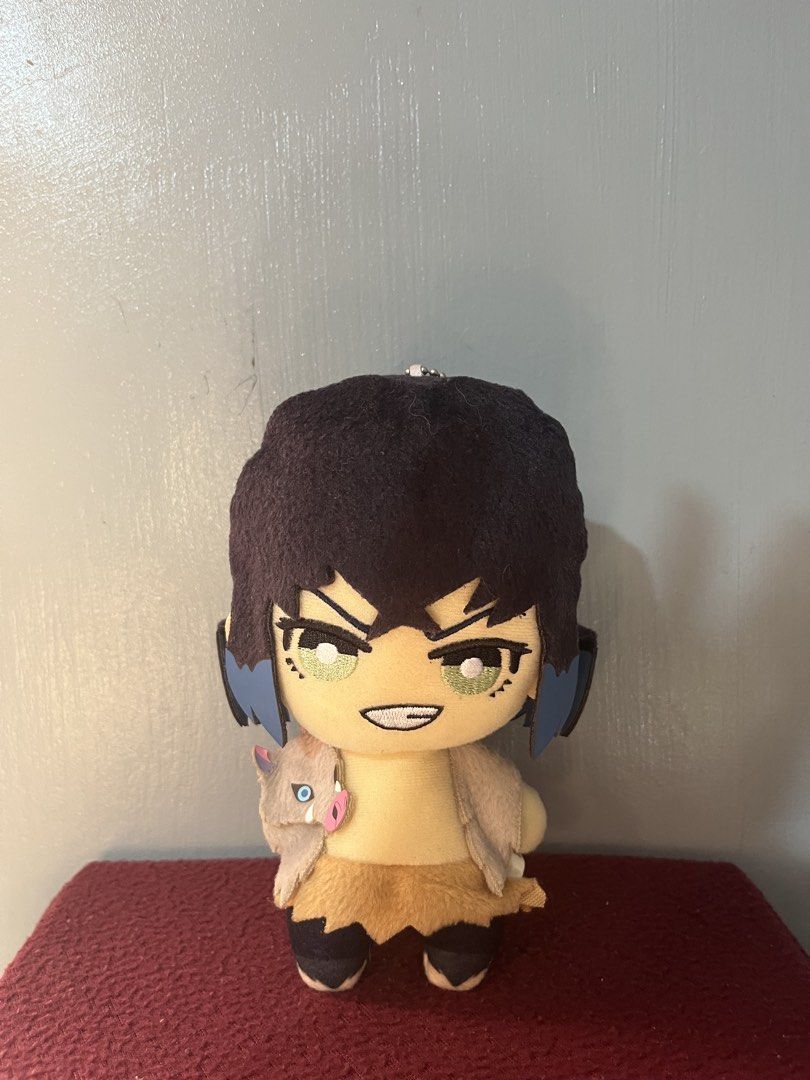 Demon Slayer Inosuke Hashibira Plush Keychain (Category: Plushies & Soft Toys) located in Baguio. Submitted by gaara1234 (Listing ID 1464971882, Image 1). Description: - Character: Inosuke Hashibira from Demon Slayer - Design: Features black hair, green eyes, and his iconic boar mask resting on the shoulder - Details: Soft fabric body with clean embroidered facial features and a brown fuzzy skirt - Hanging feature: Includes a small ball chain att