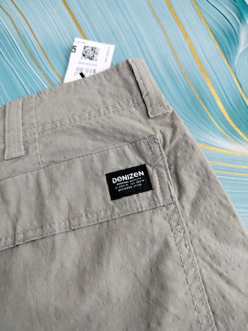 Denizen from Levi's Cargo 10" Shorts Grey W38 (Category: Shorts) located in Manila. Submitted by geraldquinto_917 (Listing ID 1464979067, Image 3). Description: - Brand: Denizen by Levi's - Style: Grey cargo shorts with original tags attached - Size: W38 - Material: Flex lightweight fabric for all-day comfort - Storage: Multiple secure pockets, featuring a convenient zip pocket on the right leg.