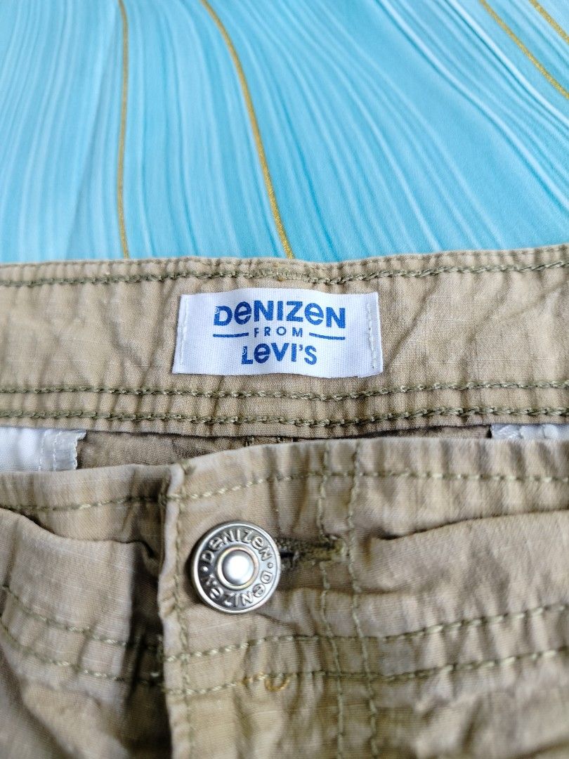 Denizen from Levi's Khaki Cargo Shorts Size 40 (Category: Shorts) located in Manila. Submitted by geraldquinto_917 (Listing ID 1464979128, Image 3). Description: - Brand: Denizen from Levi's - Style: Khaki cargo shorts with textured fabric - Size: 40 - Features: Multiple pockets, including secure zippered side cargo pockets, button closure, and zipper fly - Condition: Pre-loved with some stains on the front leg area (please check photos).