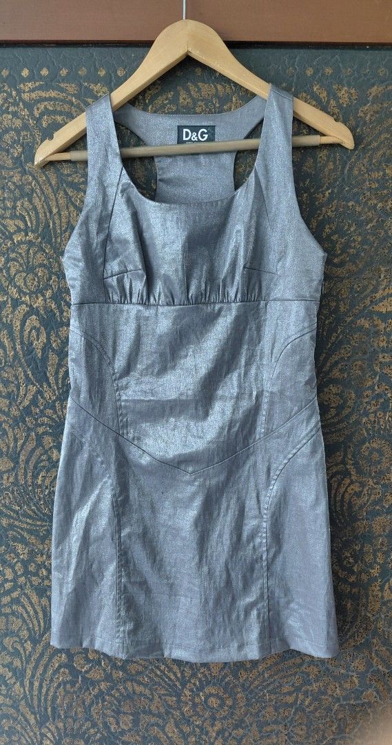 💯D&G Silver Metallic Mini Dress (Category: Dresses) located in Mandaluyong City. Submitted by arlene2560 (Listing ID 1465088719, Image 1). Description: 💯 VINTAGE DOLCE & GABBANA metallic mini tank dress featuring a scoop neckline and distinctive panel stitching. Large on tag, fits a medium or armpit 18", length is 33". Decluttering P1800. Mandaluyong Brand: D&G - Style: Bodycon mini dress with racerback and scoop neckline - Details: Eye-catchin