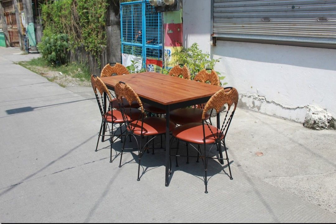 Dining Set (Category: Tables & Sets) located in Meycauayan. Submitted by marygracecasimiro (Listing ID 1465117103, Image 3). Description: 6-Seater Dining Set Vintage-inspired 6-seater dining set with six chairs with woven rattan backrests, padded leather seats and black metal frames. Warm wood-grain dining table with a sturdy black metal base. Perfect for dining areas and classic interiors Table size L:51 ¼ • W:29 ¾ • H:29 Chairs size L:16 • W:17