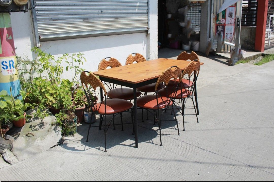 Dining Set (Category: Tables & Sets) located in Meycauayan. Submitted by marygracecasimiro (Listing ID 1465117103, Image 2). Description: 6-Seater Dining Set Vintage-inspired 6-seater dining set with six chairs with woven rattan backrests, padded leather seats and black metal frames. Warm wood-grain dining table with a sturdy black metal base. Perfect for dining areas and classic interiors Table size L:51 ¼ • W:29 ¾ • H:29 Chairs size L:16 • W:17
