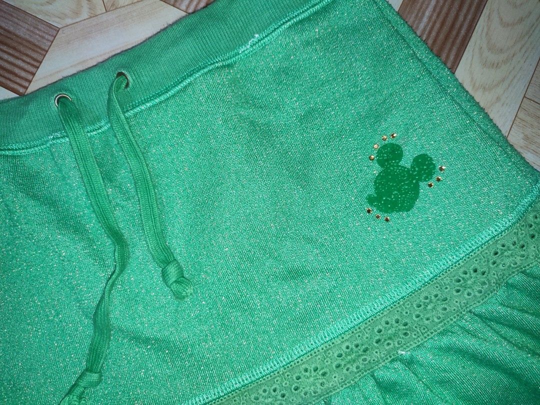 Disney Green Mickey Mouse Sparkly Skirt (Category: Skirts) located in Caloocan City. Submitted by faesrie (Listing ID 1465017837, Image 2). Description: - Official Disney merchandise with tag inside - Beautiful green fabric with subtle sparkle throughout - Comfortable adjustable drawstring waist - Cute lace trim tier at the bottom - Fun and playful statement piece.