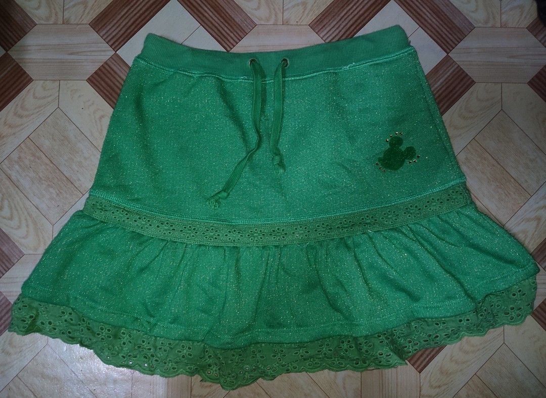 Disney Green Mickey Mouse Sparkly Skirt (Category: Skirts) located in Caloocan City. Submitted by faesrie (Listing ID 1465017837, Image 1). Description: - Official Disney merchandise with tag inside - Beautiful green fabric with subtle sparkle throughout - Comfortable adjustable drawstring waist - Cute lace trim tier at the bottom - Fun and playful statement piece.