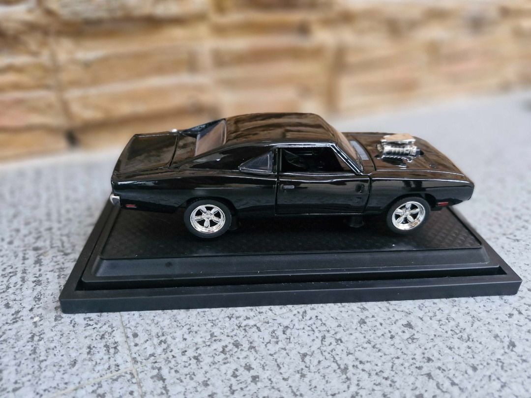 Dodge Challenger Diecast Model Black (Category: Vehicle & Diecast Models) located in Davao. Submitted by j_guitarist (Listing ID 1465146021, Image 2). Description: - Size: Length 16.5cm x width 6cm x height 4.5cm - Scale: 1:32 - Color: Black - Material: alloy (body), ABS plastic (bottom), rubber (wheel) - Display: Includes a black display base with the brand name plate - Features: Doors and front/trunk open smoothly. Sounds and lights effect. - C