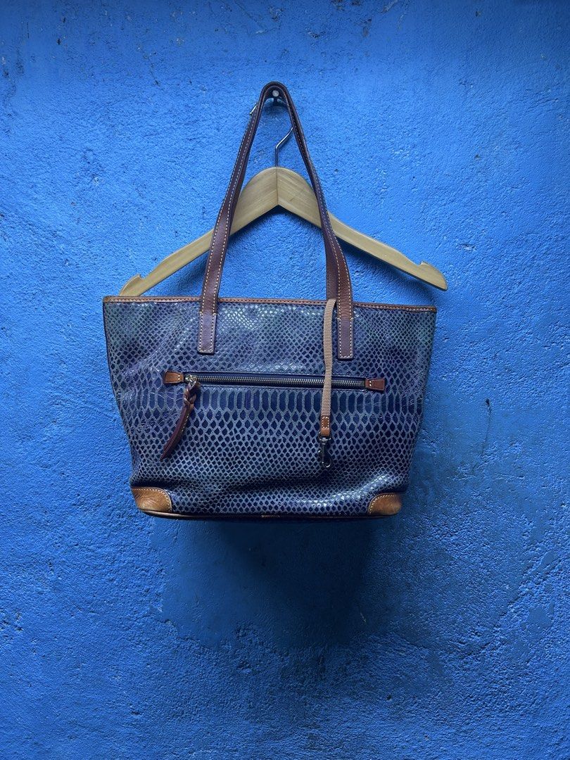 Dooney & Bourke Python Print Leather Tote Bag (Category: Luxury Bags & Wallets) located in Quezon City. Submitted by thriftxgoods (Listing ID 1465078547, Image 3). Description: - Authentic Dooney & Bourke tote bag - Blue-purple python snakeskin embossed leather with tan leather straps and trim - Exterior back zipper pocket and metal brand logo plate - Vibrant red fabric lining with multiple interior slip and zip pockets - Sturdy structured base, 