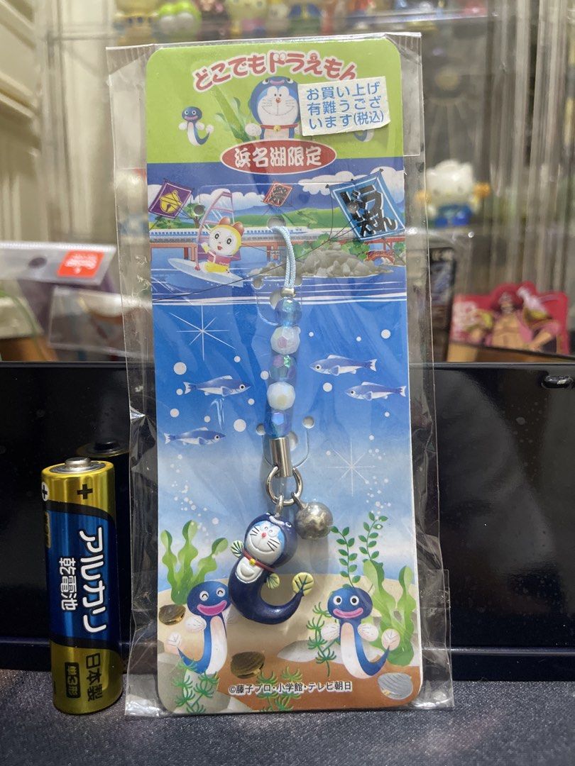Doraemon Hamana-ko Limited Edition Strap Keyring (Category: Character Goods) located in Agdangan. Submitted by kuradekawaii_06 (Listing ID 1465100627, Image 1). Description: - Authentic Hamana-ko limited collection Doraemon character strap - Unique design features Doraemon as a fish with blue beads and a small bell - Official Shopro merchandise, made in China - Brand new in original sealed packaging with Epoch barcode and manufacturer details - R