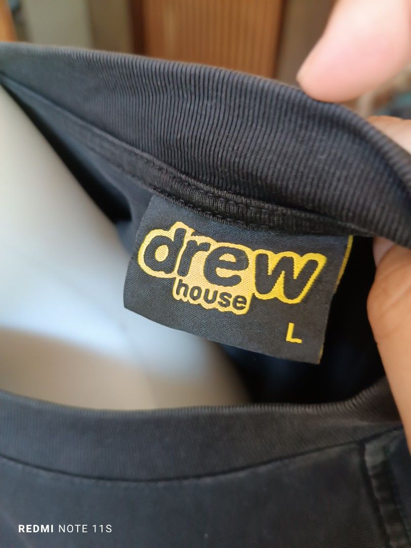 Drew House Mascot Tee Black Size L (Category: Tshirts & Polo Shirts ) located in Gapan. Submitted by thrift2heaven (Listing ID 1465088608, Image 2). Description: - Brand: Drew House - Color: Black with large yellow smiley graphic - Size: L (Tag on collar) - Material: 100% Cotton, Made in Vietnam - Fit: Relaxed fit with short sleeves - Condition: Excellent streetwear piece.