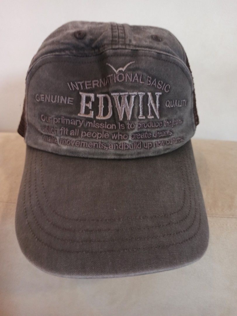 Edwin International Basic Genuine Quality Trucker Hat Cap (Category: Caps & Hats) located in Caloocan City. Submitted by rtarellano (Listing ID 1464993094, Image 1). Description: - Brand: Edwin - Style: Mesh back trucker cap - Color: Brown and gray with embroidered text - Fit: Adjustable strap closure with metal buckle hardware - Comfort: Breathable mesh panels for a cool fit - Details: Includes official branded inside fabric tag - Vibe: Great ev